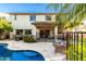 Spacious backyard featuring a large pool, patio area, lush plants, and a two-story home at 2744 E Donato Dr, Gilbert, AZ 85298