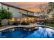 Inviting backyard pool area with covered patio, lounge chairs and a well-manicured landscape at 2744 E Donato Dr, Gilbert, AZ 85298