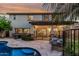 Inviting backyard pool area with covered patio, lounge chairs and lush vegetation at 2744 E Donato Dr, Gilbert, AZ 85298