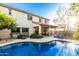 Beautiful backyard with a sparkling pool, well-maintained lawn, and a two-story house at 2744 E Donato Dr, Gilbert, AZ 85298