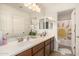 Bathroom featuring a double sink vanity, a large mirror, and a separate shower at 2744 E Donato Dr, Gilbert, AZ 85298