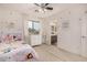 Bedroom with a unicorn themed bed, dresser, window with drapes, and an ensuite bathroom at 2744 E Donato Dr, Gilbert, AZ 85298