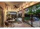 Covered patio with outdoor seating, ceiling fan, lighting and view of the green backyard at 2744 E Donato Dr, Gilbert, AZ 85298