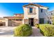 Charming two-story home with stone accents, a well-manicured front yard and a two car garage at 2744 E Donato Dr, Gilbert, AZ 85298