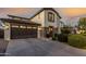 Stunning exterior elevation featuring a well-maintained lawn, stone accents, and an attached two-car garage at 2744 E Donato Dr, Gilbert, AZ 85298