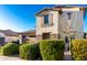 Attractive home facade with an attached garage, decorative shutters, and lush, mature bushes at 2744 E Donato Dr, Gilbert, AZ 85298