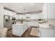 Bright kitchen featuring white cabinets, an island with countertop, stainless steel appliances and dark wood floors at 2744 E Donato Dr, Gilbert, AZ 85298