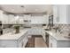Bright kitchen features white cabinetry, granite countertops, stainless steel appliances and decorative tile backsplash at 2744 E Donato Dr, Gilbert, AZ 85298