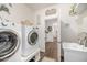 Well-equipped laundry room with modern appliances, a utility sink, and ample space at 2744 E Donato Dr, Gilbert, AZ 85298