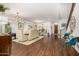 Spacious living room featuring staircase, luxury vinyl flooring and dining area at 2744 E Donato Dr, Gilbert, AZ 85298