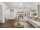 Open-concept living area with wood floors, a comfortable sectional, and a view into the kitchen at 2744 E Donato Dr, Gilbert, AZ 85298