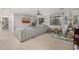 Spacious living area with neutral colors, a large sofa, and a ceiling fan at 2744 E Donato Dr, Gilbert, AZ 85298