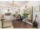 An eclectic living room with high ceilings, wood floors, large mirrors and artistic decor at 2744 E Donato Dr, Gilbert, AZ 85298