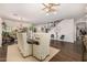 Spacious living room featuring staircase, luxury vinyl flooring and dining area at 2744 E Donato Dr, Gilbert, AZ 85298