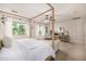 Elegant bedroom showcasing a four-poster bed, ample natural light, and stylish furnishings at 2744 E Donato Dr, Gilbert, AZ 85298