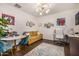 Office with a couch, desk, chair, and a modern light fixture at 2744 E Donato Dr, Gilbert, AZ 85298