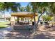 Community picnic area with shaded seating, BBQ grills, and lush landscaping, perfect for outdoor gatherings at 2744 E Donato Dr, Gilbert, AZ 85298