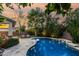 Relaxing pool area with lush landscaping, pool lights, seating, and a view of the property at 2744 E Donato Dr, Gilbert, AZ 85298