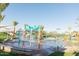 Community splash pad with multiple water features, palm trees, and shade structures for outdoor fun at 2744 E Donato Dr, Gilbert, AZ 85298