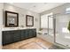 Bright bathroom with double sinks, granite countertops, a soaking tub, and a separate glass enclosed shower at 2829 W Haley Dr, Anthem, AZ 85086