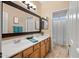 Bathroom featuring tile floors, a double sink vanity, and an enclosed toilet and shower at 2829 W Haley Dr, Anthem, AZ 85086