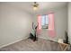 Well-lit bedroom featuring neutral paint, carpeted floors, a ceiling fan, and window with pink curtains at 2829 W Haley Dr, Anthem, AZ 85086