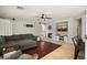 Cozy living room with fireplace, hardwood accents, large sectional, and a ceiling fan at 2829 W Haley Dr, Anthem, AZ 85086