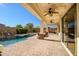An inviting outdoor patio with ceiling fans and a scenic view of the sparkling pool and waterfall feature at 2829 W Haley Dr, Anthem, AZ 85086
