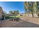 Backyard features a gravel area with fire pit and chairs and artificial turf at 3124 W Redbird Rd, Phoenix, AZ 85083