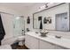 A well-lit bathroom with a double sink vanity, modern fixtures, and sleek shower/tub combo at 3124 W Redbird Rd, Phoenix, AZ 85083