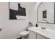 Stylish powder room with modern fixtures, decorative art, and clean design at 3124 W Redbird Rd, Phoenix, AZ 85083