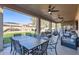 Relaxing covered patio with ceiling fans, dining and lounge furniture, and views of the backyard at 3124 W Redbird Rd, Phoenix, AZ 85083