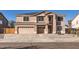 Two-story home featuring a driveway, a two-car garage, and solar panels on the roof at 3124 W Redbird Rd, Phoenix, AZ 85083