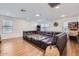 Large recreational room featuring a comfortable sectional sofa, pinball machine, and ample space for entertaining at 3124 W Redbird Rd, Phoenix, AZ 85083