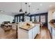Open-concept kitchen with white cabinets, granite countertops, and bar seating overlooking living area at 3124 W Redbird Rd, Phoenix, AZ 85083