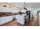 Modern kitchen featuring white cabinets, stainless steel appliances, and a center island with bar seating at 3124 W Redbird Rd, Phoenix, AZ 85083