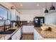 Well-lit kitchen featuring granite countertops, stainless appliances, white cabinets, and a sleek black fridge at 3124 W Redbird Rd, Phoenix, AZ 85083