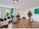 Bright living room with light wood floors, a white sofa, and a large window at 3124 W Redbird Rd, Phoenix, AZ 85083