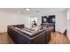 Spacious living room featuring a large sectional sofa, hardwood floors, and a modern entertainment center at 3124 W Redbird Rd, Phoenix, AZ 85083