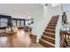 Open-concept living room with hardwood floors, staircase, and dining area in a beautifully designed home at 3124 W Redbird Rd, Phoenix, AZ 85083