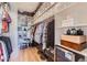Large walk-in closet with custom shelving, ample storage and organization, and hardwood floors at 3124 W Redbird Rd, Phoenix, AZ 85083