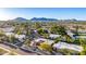 Expansive aerial shot showcasing the neighborhood's well-maintained homes and lush landscaping with a mountain view at 3226 E Lazy Ln, Phoenix, AZ 85028