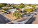 Aerial shot of a well-maintained home with a tile roof, desert landscaping, and mature trees at 3226 E Lazy Ln, Phoenix, AZ 85028