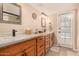 Bathroom features a dual sink vanity with ample storage and modern fixtures with door to exterior at 3226 E Lazy Ln, Phoenix, AZ 85028