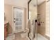 Bright bathroom features a glass shower and an exterior door for easy access to the outdoors at 3226 E Lazy Ln, Phoenix, AZ 85028
