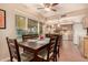 Cozy dining area with terracotta flooring, leading to a modern kitchen and a view of the outdoor space at 3226 E Lazy Ln, Phoenix, AZ 85028