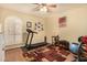 Bright exercise room featuring a treadmill, weights, and ceiling fan for a home fitness experience at 3226 E Lazy Ln, Phoenix, AZ 85028