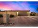Spacious two-car garage with brick driveway, block wall, and well-maintained landscaping at 3226 E Lazy Ln, Phoenix, AZ 85028