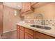 Well-lit laundry room with a sink, ample counter space, and wooden cabinets at 3226 E Lazy Ln, Phoenix, AZ 85028
