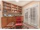 Sitting area featuring built in bookshelves and cabinets plus french doors to let the outside in at 3226 E Lazy Ln, Phoenix, AZ 85028